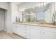 Bright bathroom featuring double vanity with granite countertops and modern fixtures and large mirror at 1809 Hanwoo Ln, Powder Springs, GA 30127