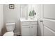 Elegant half bathroom featuring a modern vanity, sleek fixtures, and a stylish mirror at 1809 Hanwoo Ln, Powder Springs, GA 30127