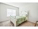 Bright bedroom features a white bed frame, neutral carpet, and natural light from the window at 1809 Hanwoo Ln, Powder Springs, GA 30127