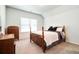 Cozy bedroom featuring a bed with a decorative wooden headboard and vintage dresser at 1809 Hanwoo Ln, Powder Springs, GA 30127