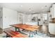 Bright dining area with a long wooden table and bench seating, adjacent to the kitchen at 1809 Hanwoo Ln, Powder Springs, GA 30127