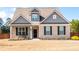 Charming single-Gathering home with brick facade, covered front porch, and manicured landscaping at 1809 Hanwoo Ln, Powder Springs, GA 30127