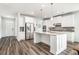 Bright kitchen with stainless steel appliances, white cabinets, island and gray backsplash at 1809 Hanwoo Ln, Powder Springs, GA 30127