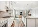 Modern white kitchen featuring stainless steel appliances, granite countertops, and open layout at 1809 Hanwoo Ln, Powder Springs, GA 30127