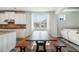 Bright eat-in kitchen features white cabinets, granite countertops, and modern wood table at 1809 Hanwoo Ln, Powder Springs, GA 30127