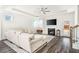 Spacious living room with fireplace, ceiling fan, and ample natural light from the backyard at 1809 Hanwoo Ln, Powder Springs, GA 30127