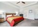 Bright main bedroom with a ceiling fan, tray ceiling and en-suite bathroom entrance at 1809 Hanwoo Ln, Powder Springs, GA 30127