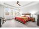 Serene main bedroom with tray ceiling, carpet and a large window at 1809 Hanwoo Ln, Powder Springs, GA 30127