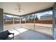 Covered screened patio with a fan and a view of the fenced backyard at 1809 Hanwoo Ln, Powder Springs, GA 30127