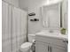 Bathroom featuring a toilet, shower with a striped shower curtain, vanity, mirror and shelving at 2005 Haley Wlk Walk, Woodstock, GA 30188