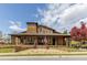 Stunning community clubhouse featuring wood siding, a covered porch, and a lovely landscaped yard at 2005 Haley Wlk Walk, Woodstock, GA 30188