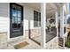 Inviting front porch with stone accents, black railing, and a 'Welcome' mat at 2005 Haley Walk, Woodstock, GA 30188