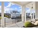 Relaxing covered porch view with white columns and neighborhood views at 2005 Haley Walk, Woodstock, GA 30188