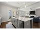 Open-concept kitchen with island seamlessly flows into the adjacent living area at 2005 Haley Wlk Walk, Woodstock, GA 30188