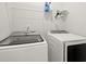 Bright laundry room equipped with Samsung washer and dryer, complemented by practical shelving above at 2005 Haley Wlk Walk, Woodstock, GA 30188