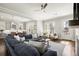 The living room flows into the kitchen, with a large grey sofa, hardwood floors, and modern appliances at 2005 Haley Walk, Woodstock, GA 30188