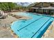 Bright pool with clearly marked lanes, lounge chairs, tables, and umbrellas for residents enjoyment at 2005 Haley Walk, Woodstock, GA 30188