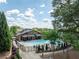 Community pool and clubhouse under a partly cloudy sky with mature trees and landscaping at 2005 Haley Wlk Walk, Woodstock, GA 30188