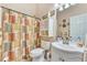 Bathroom features a vanity sink, toilet, and shower with printed curtain at 2895 Dogwood Creek Pkwy, Duluth, GA 30096