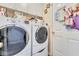 Bright laundry room features a stacked washer/dryer and plenty of storage space for convenience at 2895 Dogwood Creek Pkwy, Duluth, GA 30096