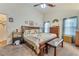 Cozy main bedroom featuring a ceiling fan and natural light from curtained windows at 2895 Dogwood Creek Pkwy, Duluth, GA 30096