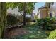 Serene backyard featuring a stone bench, lush greenery, and shade at 3786 Turnberry Ct, Duluth, GA 30096