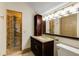 Bathroom featuring granite vanity, decorative lights, and a glass shower at 3786 Turnberry Ct, Duluth, GA 30096