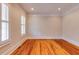 Spacious bedroom featuring natural light, hardwood floors, and decorative trim at 3786 Turnberry Ct, Duluth, GA 30096