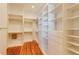 Walk-in closet featuring custom white shelving and drawers for plenty of storage space at 3786 Turnberry Ct, Duluth, GA 30096