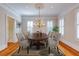 Formal dining room with hardwood floors, a decorative chandelier, and bright windows at 3786 Turnberry Ct, Duluth, GA 30096