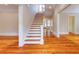 Bright foyer featuring hardwood floors and a staircase leading to the upper level at 3786 Turnberry Ct, Duluth, GA 30096