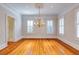 Living room with wood floors, a chandelier, and windows with plantation shutters at 3786 Turnberry Ct, Duluth, GA 30096