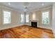 Living room with hardwood flooring, a fireplace, and large windows that provide lots of natural light at 3786 Turnberry Ct, Duluth, GA 30096