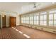 Sunroom with brick floors, wood ceilings, and windows with plantation shutters at 3786 Turnberry Ct, Duluth, GA 30096