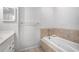 Bathroom featuring a white tub with tan tile surround, and light neutral walls at 4446 Frontier Way, Sugar Hill, GA 30518