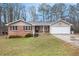 Charming single-story home with brick accents, siding, attached garage, and a well-maintained lawn at 4446 Frontier Way, Sugar Hill, GA 30518