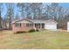 Charming single-story home with brick accents, siding, attached garage, and a well-maintained lawn at 4446 Frontier Way, Sugar Hill, GA 30518