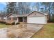 Charming single-story home with brick accents, siding, attached garage, and a long driveway at 4446 Frontier Way, Sugar Hill, GA 30518