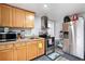 Functional kitchen with stainless steel appliances and wood cabinets at 4446 Frontier Way, Sugar Hill, GA 30518