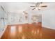 Bright living room with hardwood floors, ceiling fans, and ample natural light at 4446 Frontier Way, Sugar Hill, GA 30518