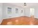 Bright living room with hardwood floors, neutral paint, natural light, and traditional chandelier at 4446 Frontier Way, Sugar Hill, GA 30518