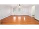 Bright living room with hardwood floors, neutral paint, natural light, and traditional chandelier at 4446 Frontier Way, Sugar Hill, GA 30518