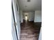 Bright entryway featuring sleek wood floors, white walls, and an open view into the home's interior at 6066 Creekford Dr, Lithonia, GA 30058