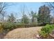 View of the private, fenced backyard with mature trees at 6745 Waveland Dr, Cumming, GA 30040