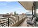 A balcony offering cityscape views features modern outdoor furniture and creates a comfortable retreat at 750 Park Ne Ave # 14Se, Atlanta, GA 30326
