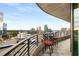 Balcony with red cushioned chairs and a view of buildings and trees at 750 Park Ne Ave # 14Se, Atlanta, GA 30326