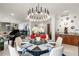 A modern dining area with a statement chandelier, piano, round table, and tasteful decor and furnishings at 750 Park Ne Ave # 14Se, Atlanta, GA 30326