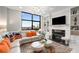 Bright living room featuring large window with city views, fireplace, and modern decor at 750 Park Ne Ave # 14Se, Atlanta, GA 30326