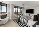 Spacious main bedroom suite featuring a sitting area, cityscape views, and sophisticated decor at 750 Park Ne Ave # 14Se, Atlanta, GA 30326