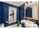 Chic powder room with dark blue walls, a decorative mirror, and stylish fixtures, adding a touch of sophistication at 750 Park Ne Ave # 14Se, Atlanta, GA 30326